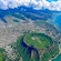 A city next to a large volcanic crater and the ocean